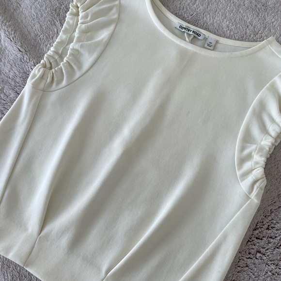 Modern, structured white top with ruched, cap short sleeves & waist pleats. - Picture 6 of 8